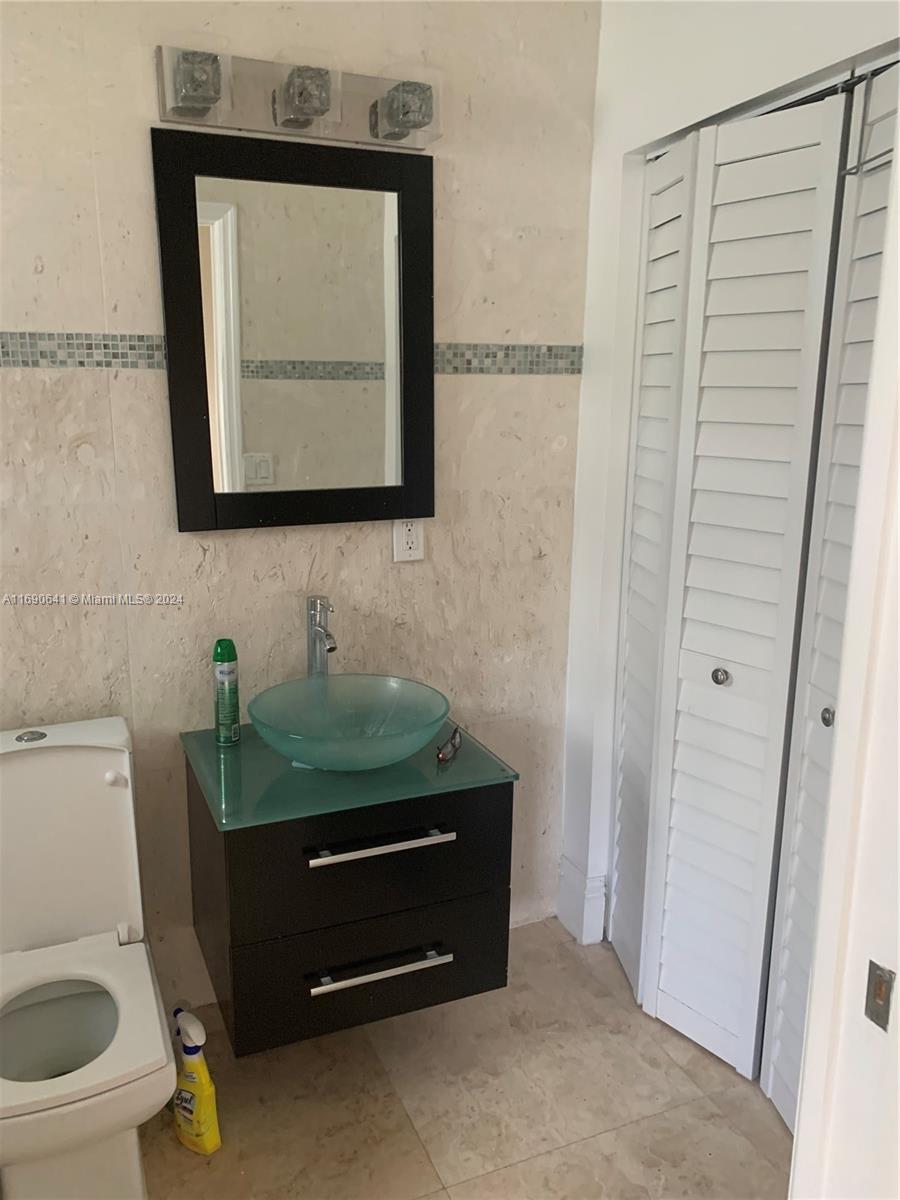 310 191st Terrace Sunny Isles Beach, FL 33160 - Photo 29 of 36 a bathroom with a toilet and a sink