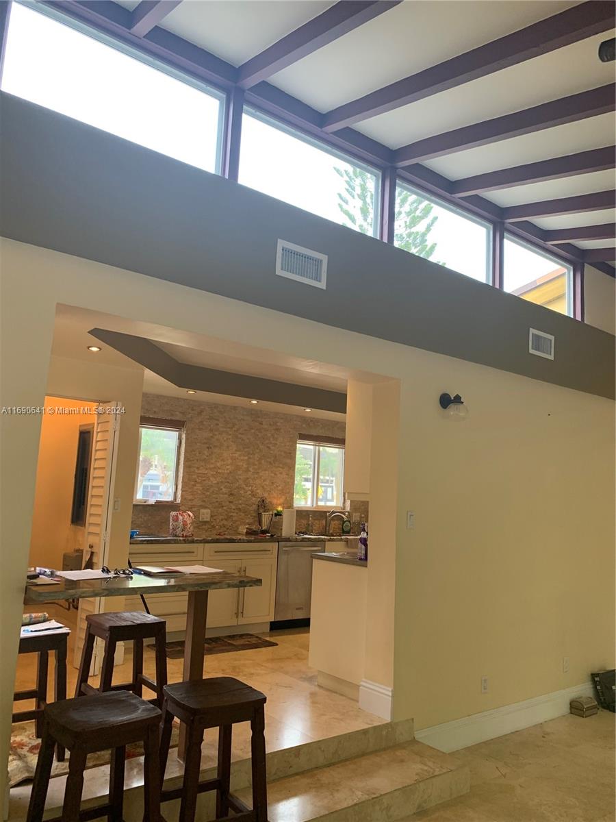 310 191st Terrace Sunny Isles Beach, FL 33160 - Photo 9 of 36 a kitchen with a table and chairs in it