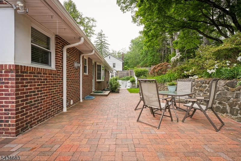 106 Division Avenue Summit, NJ 07901 - Photo 33 of 38 a view of a patio with a table and chairs and potted plants