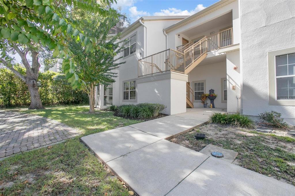 970 North Spring Garden Avenue, Unit 311 DeLand, FL 32720 - Photo 2 of 16 a view of a white house with a yard and plants