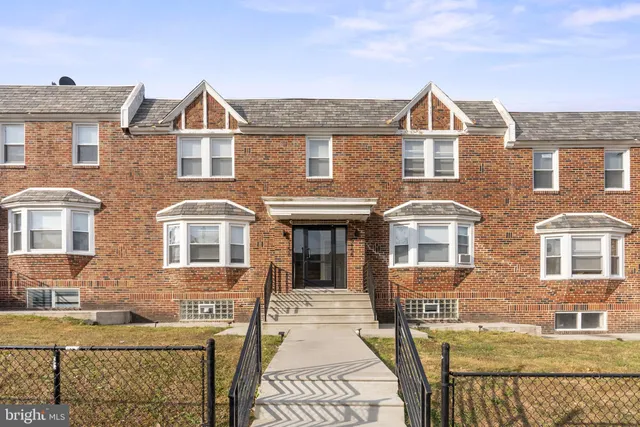 a view of a brick house with large windows