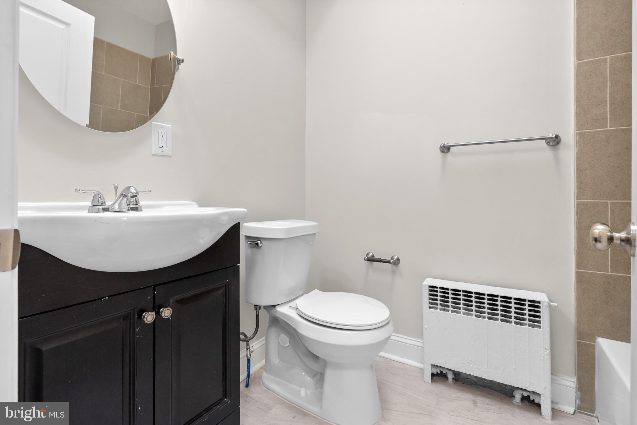 5160 D Street, Unit 2 Philadelphia, PA 19120 - Photo 9 of 23 a bathroom with a sink a toilet and mirror
