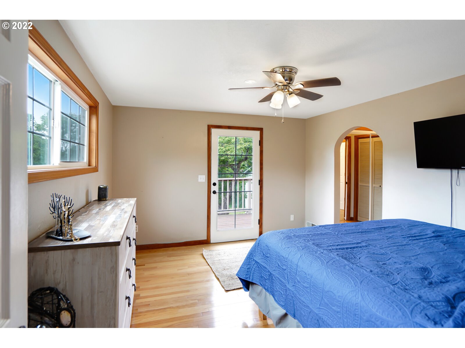 14997 Orchard Knob Road Dallas, OR 97338 - Photo 10 of 32 a bedroom with a bed and a chandelier