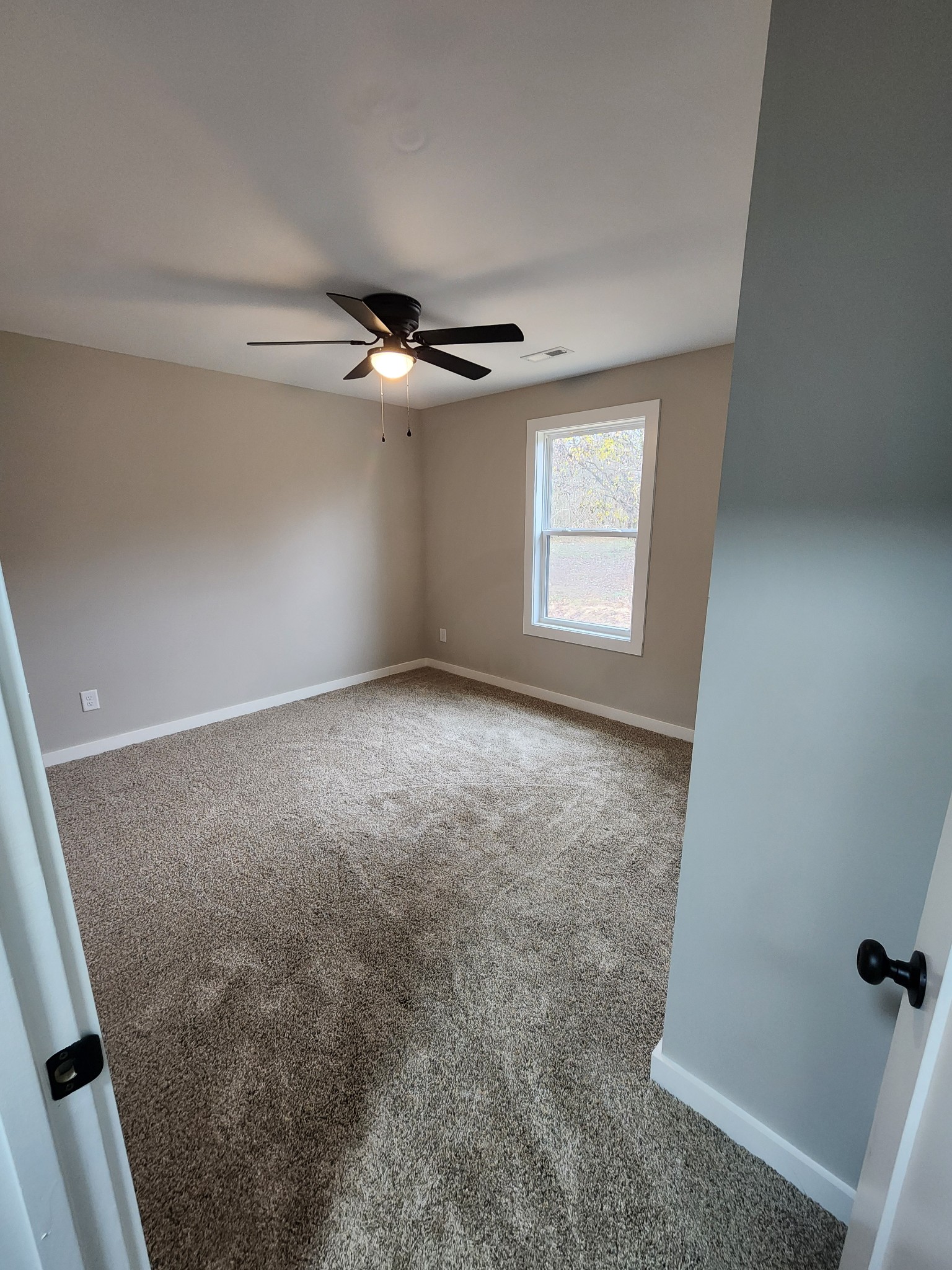 2006 Errel Dowlen Road Pleasant View, TN 37146 - Photo 11 of 15 an empty room with windows and fan