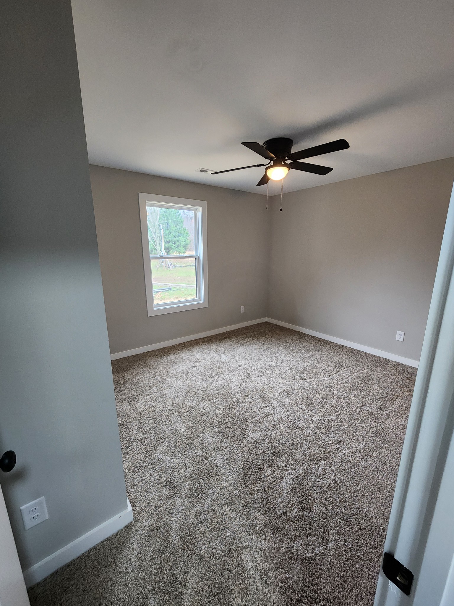 2006 Errel Dowlen Road Pleasant View, TN 37146 - Photo 12 of 15 an empty room with windows and fan