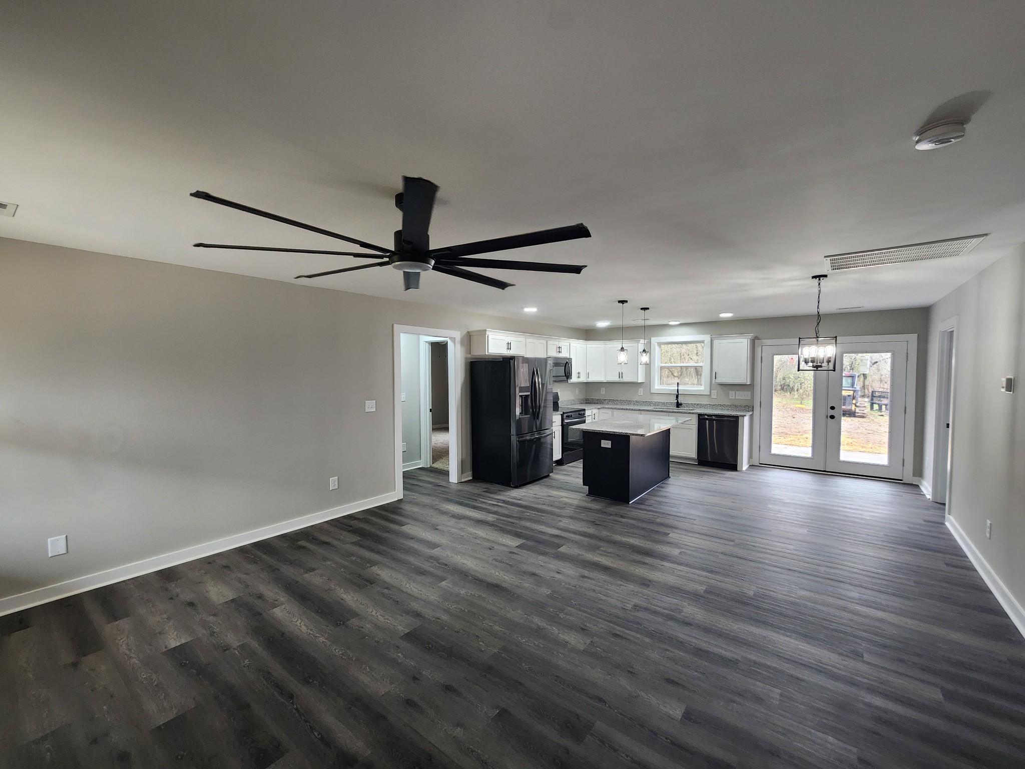 2006 Errel Dowlen Road Pleasant View, TN 37146 - Photo 13 of 15 an empty room with wooden floor chandelier and windows