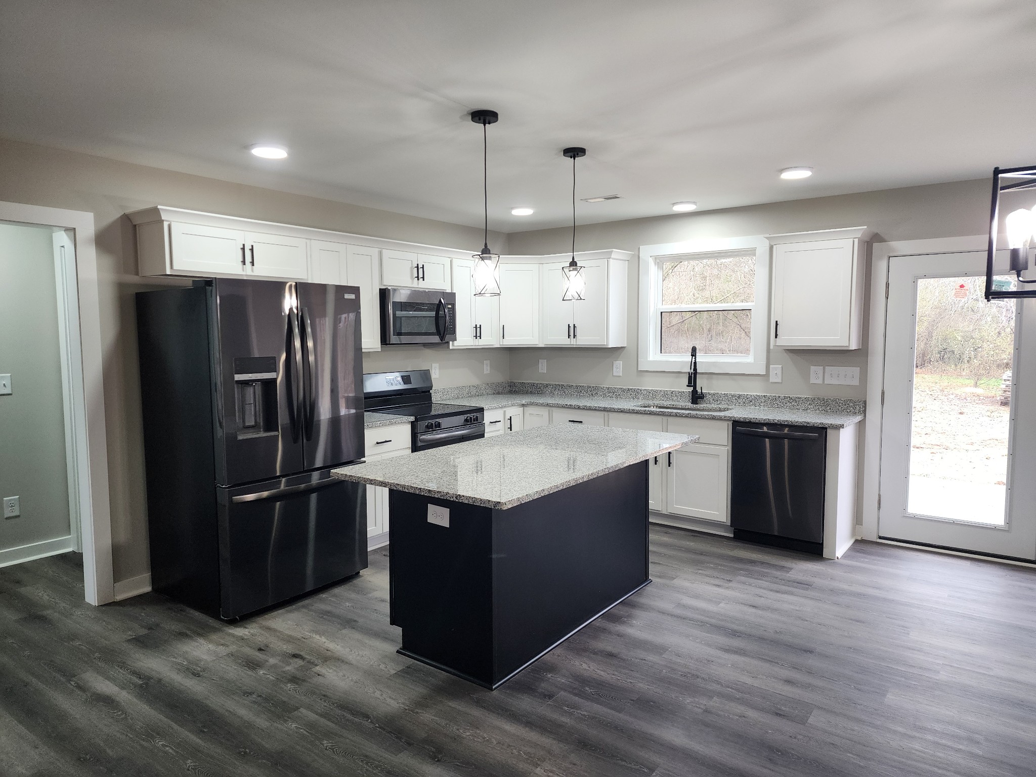 2006 Errel Dowlen Road Pleasant View, TN 37146 - Photo 15 of 15 a kitchen with stainless steel appliances granite countertop a refrigerator a sink dishwasher a stove with white cabinets and wooden floor
