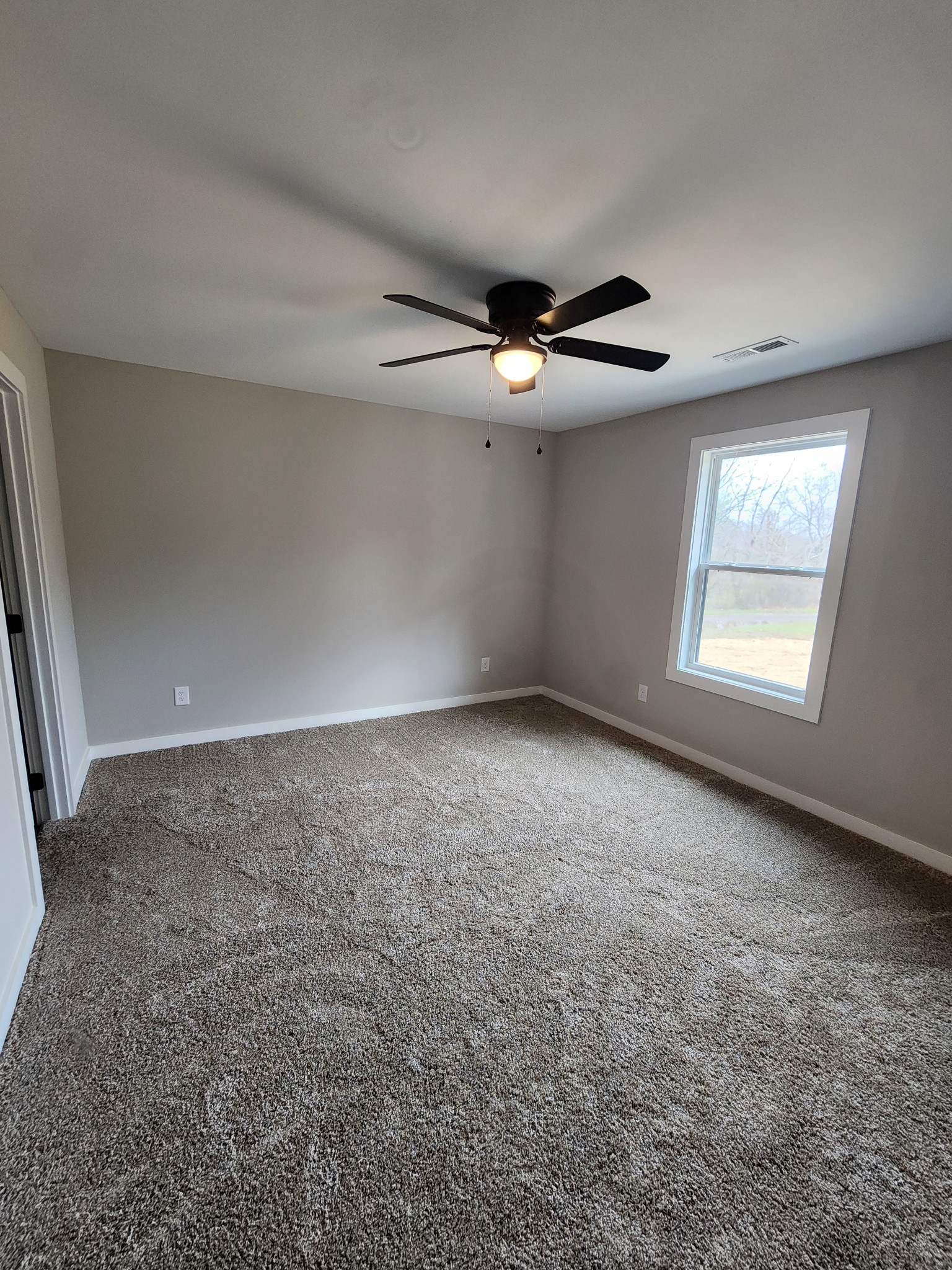 2006 Errel Dowlen Road Pleasant View, TN 37146 - Photo 5 of 15 an empty room with chandelier fan and windows