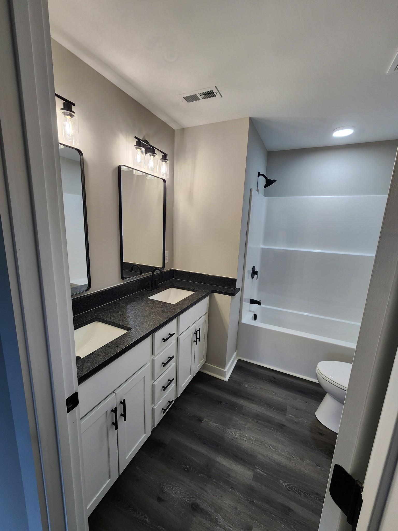 2006 Errel Dowlen Road Pleasant View, TN 37146 - Photo 7 of 15 a spacious bathroom with a granite countertop sink and a mirror
