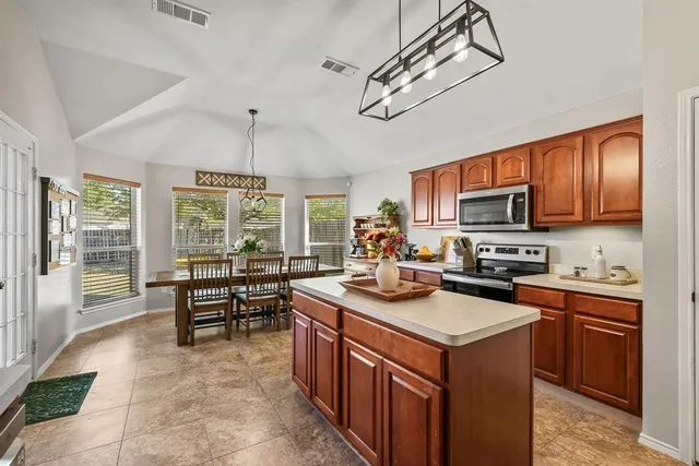 a kitchen with sink stove and cabinets