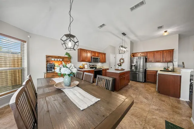 a view of a dining room with furniture large windows and wooden floor