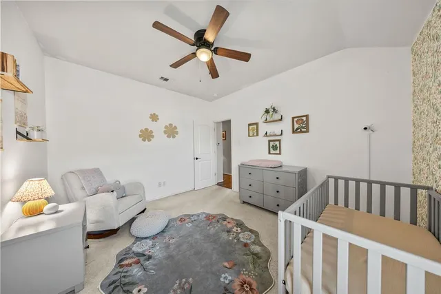a bedroom with a bed and a bookshelf