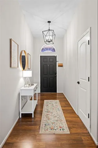 a view of an entryway with wooden floor