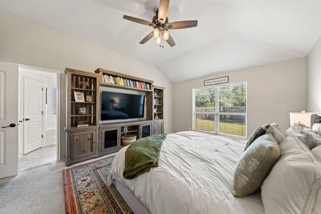 a bedroom with furniture and a flat screen tv