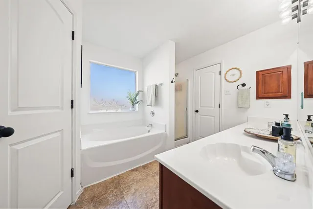 a bathroom with a bathtub and a shower