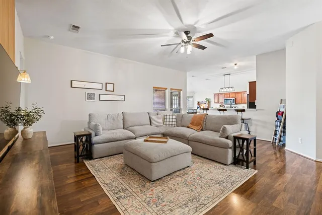 a living room with furniture and wooden floor