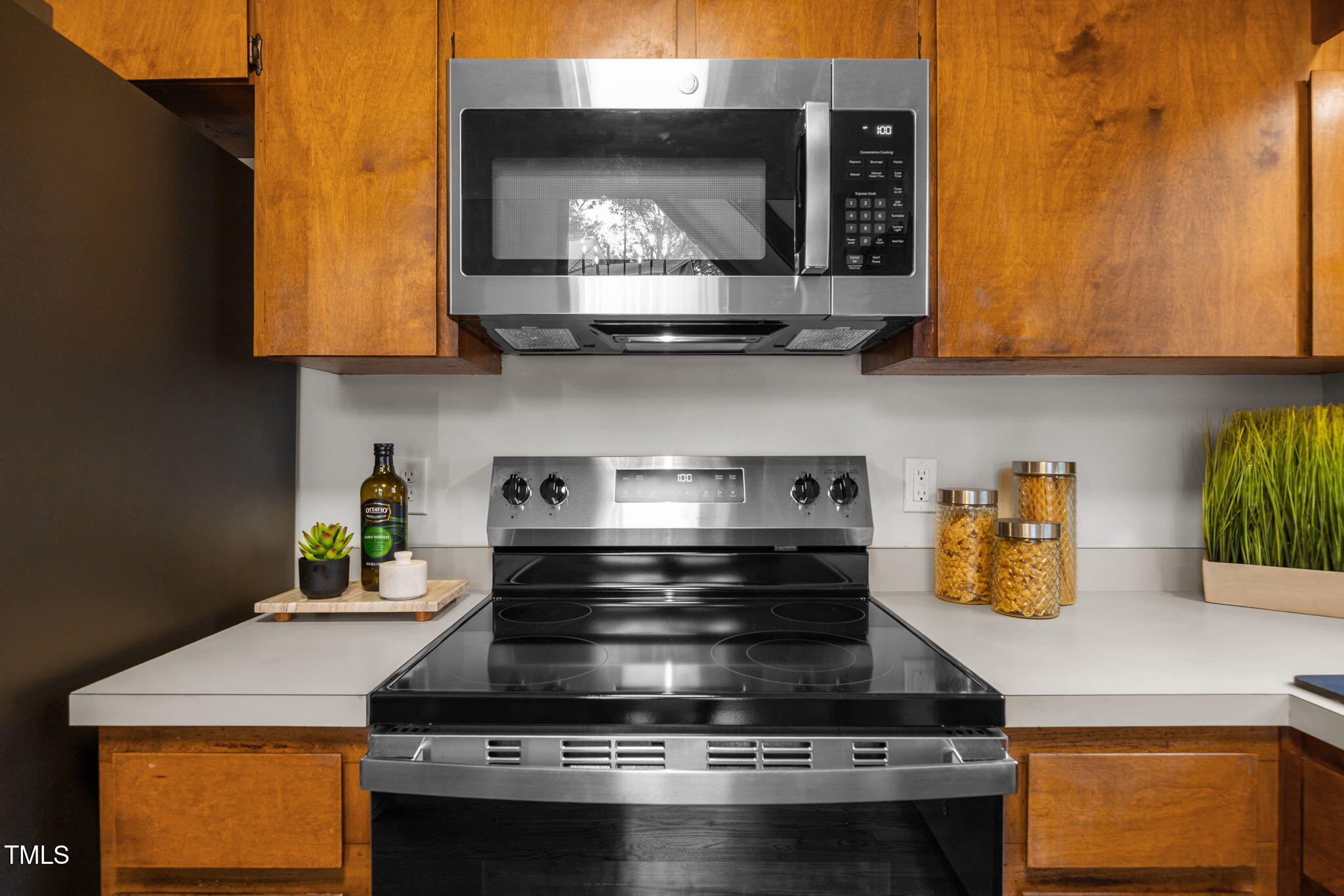2508 Village Grove Road Raleigh, NC 27613 - Photo 14 of 36 a kitchen with stainless steel appliances granite countertop a stove and a microwave