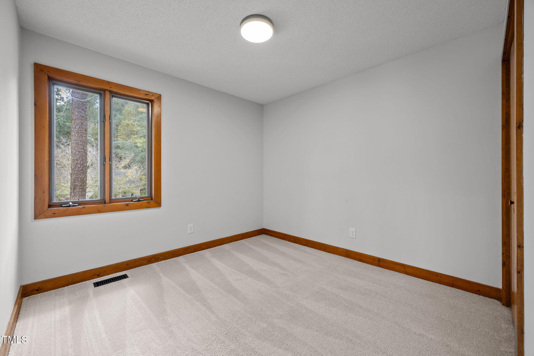 2508 Village Grove Road Raleigh, NC 27613 - Photo 16 of 36 a view of an empty room with a window