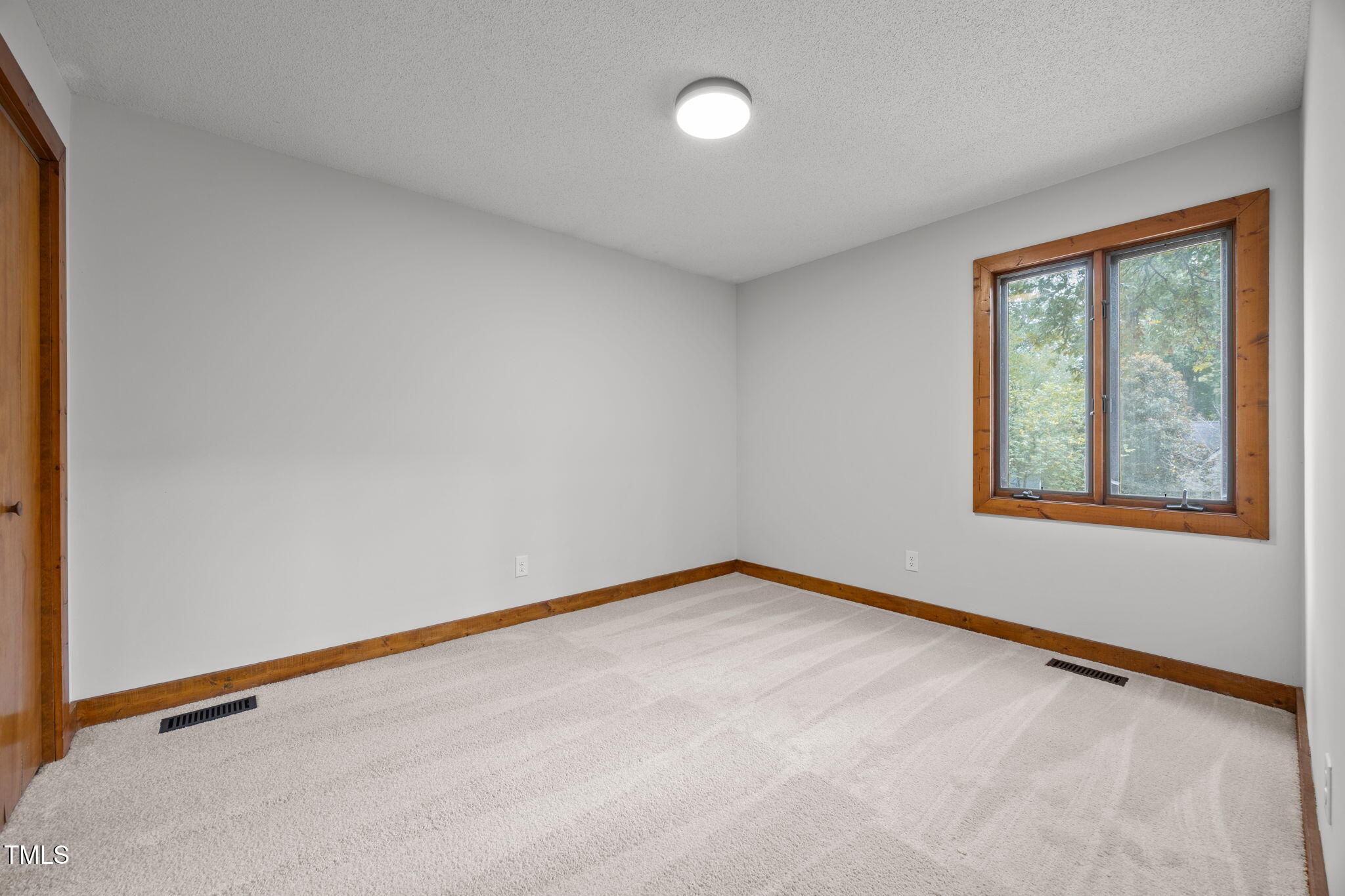 2508 Village Grove Road Raleigh, NC 27613 - Photo 18 of 36 a view of an empty room with a window