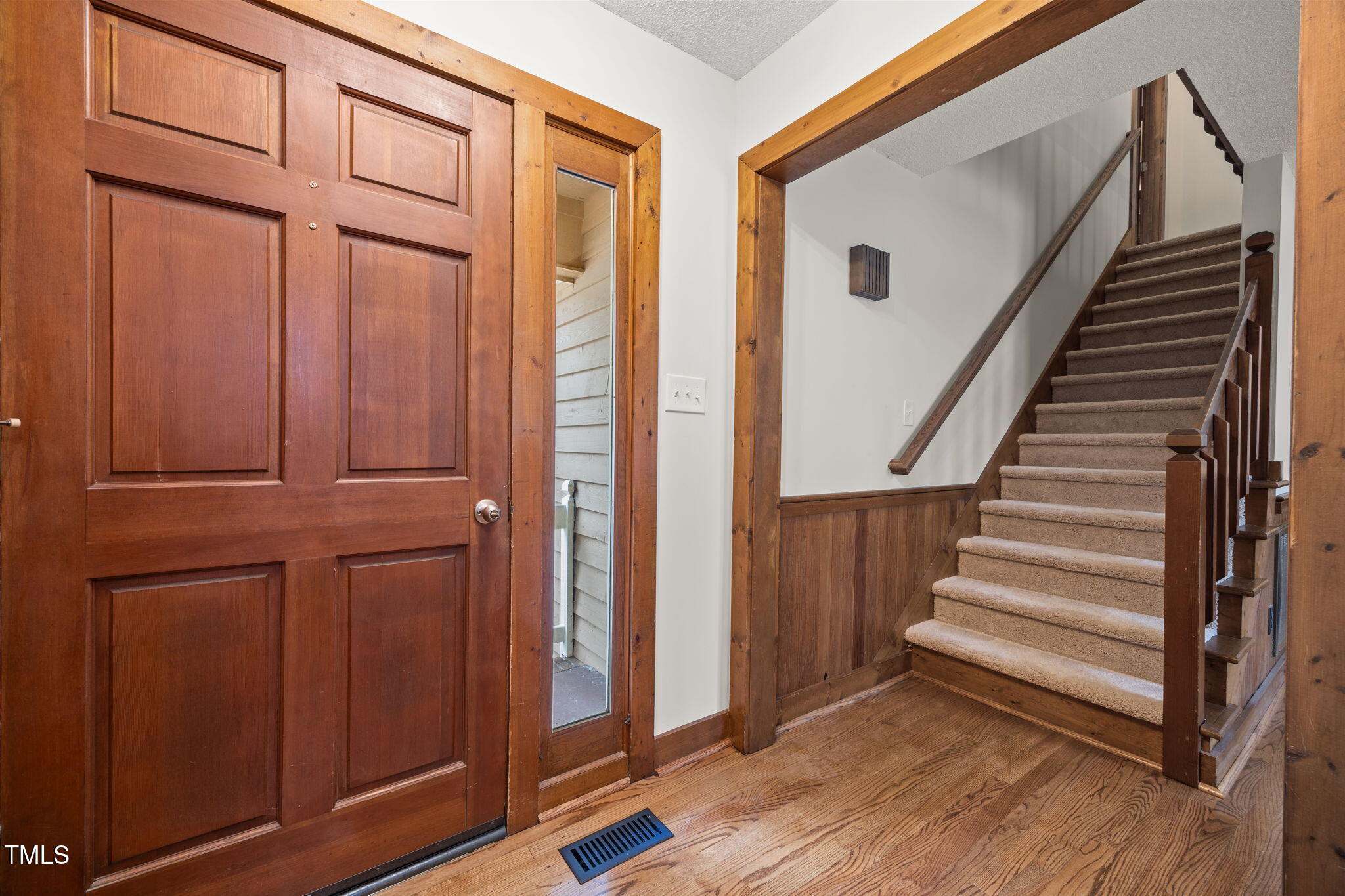2508 Village Grove Road Raleigh, NC 27613 - Photo 3 of 36 a view of front door with wooden floor and stairs