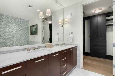 a spacious bathroom with a bathtub sink and mirror
