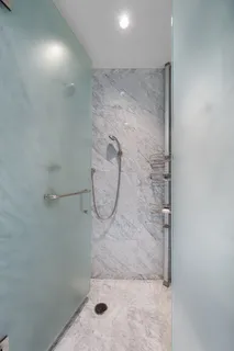 a spacious bathroom with a large tub shower and sink