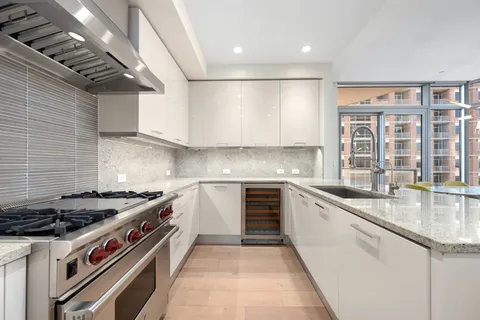a kitchen with stainless steel appliances granite countertop a stove and a sink