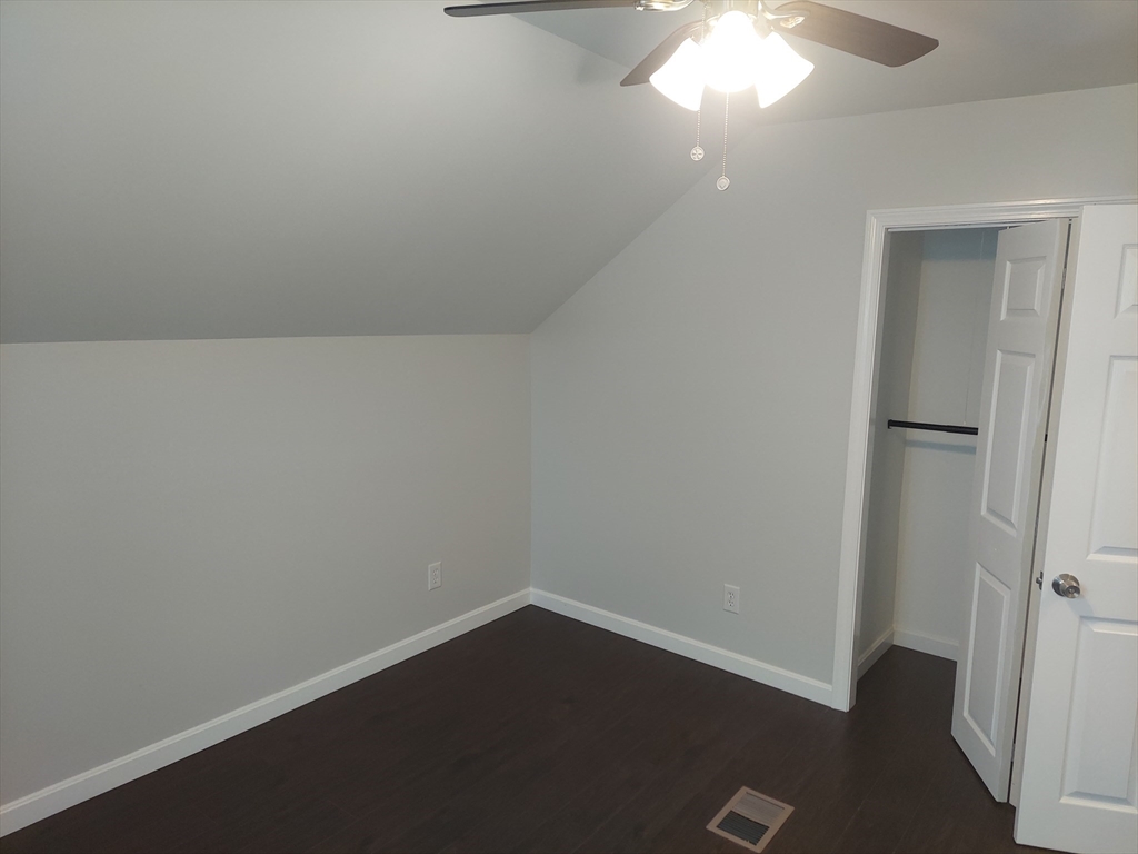 8 Phillips Street Attleboro, MA 02703 - Photo 14 of 17 an empty room with wooden floor and windows