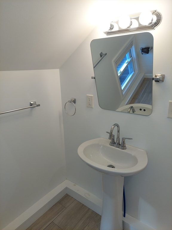 8 Phillips Street Attleboro, MA 02703 - Photo 15 of 17 a bathroom with a sink a mirror and vanity