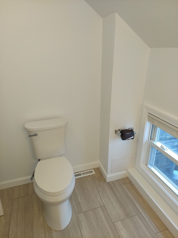 8 Phillips Street Attleboro, MA 02703 - Photo 16 of 17 a white toilet sitting next to a window