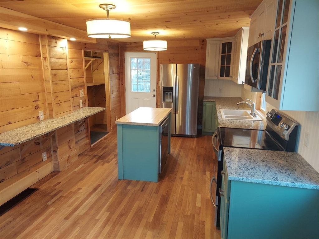 8 Phillips Street Attleboro, MA 02703 - Photo 6 of 17 a large kitchen with stainless steel appliances granite countertop a lot of counter space and wooden floor