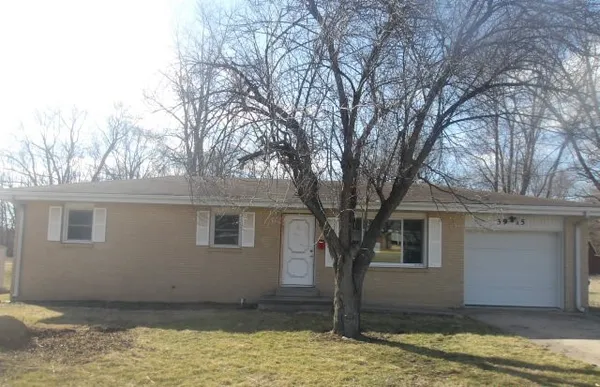 a house that has a tree in front of it