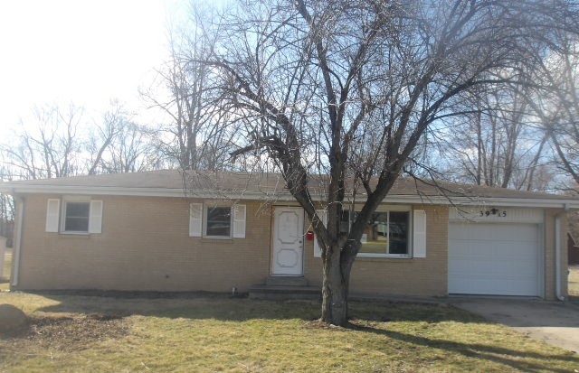 a house that has a tree in front of it