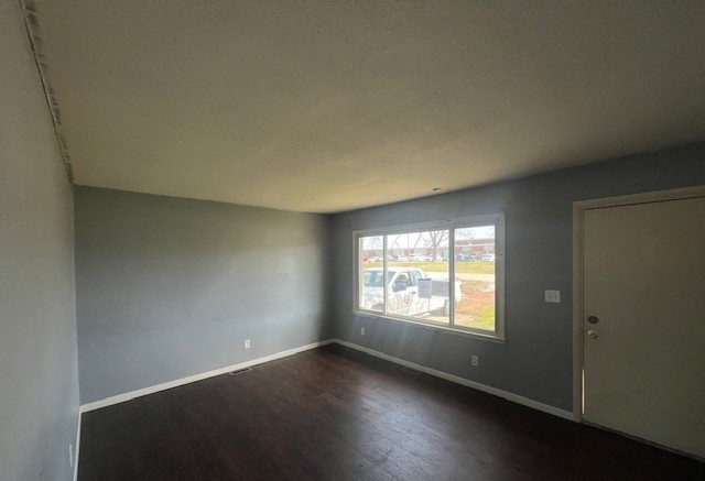 3915 Neeley Avenue Decatur, IL 62526 - Photo 2 of 19 an empty room with wooden floor and windows