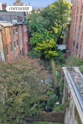 a view of a backyard with plants and outdoor seating