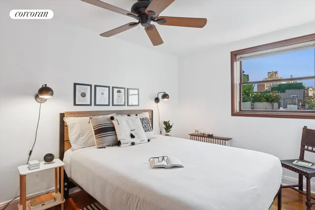 a bedroom with a bed and a window