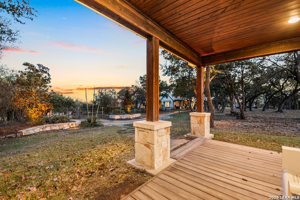 292 Fossil Ridge Boerne, TX 78006 - Photo 137 of 144 a view of a patio with a table and chairs next to a yard