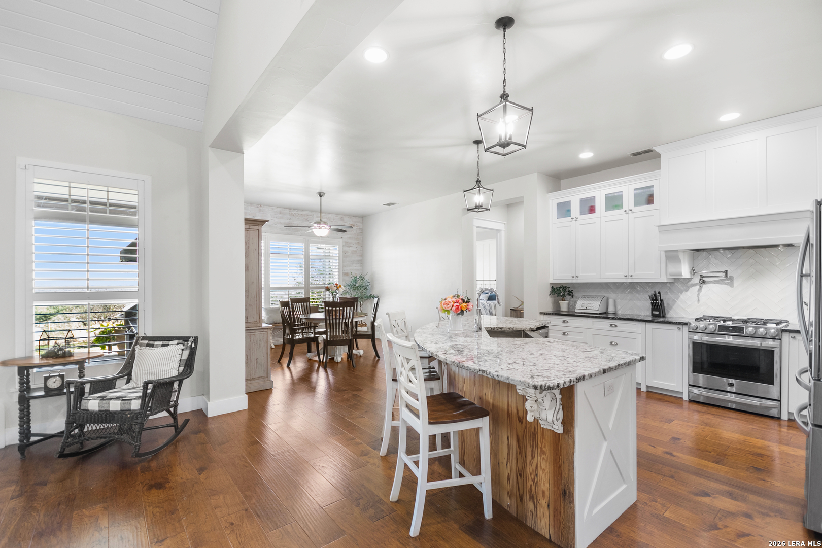 292 Fossil Ridge Boerne, TX 78006 - Photo 19 of 144 a open kitchen with stainless steel appliances granite countertop a stove center island a dining table and chairs with wooden floor