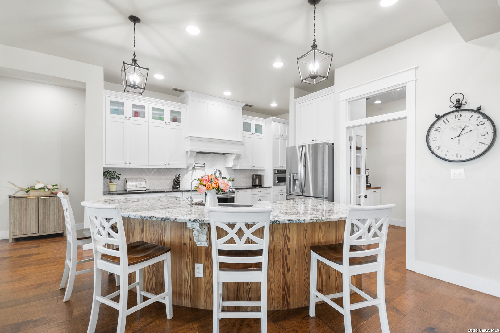 292 Fossil Ridge Boerne, TX 78006 - Photo 21 of 144 a kitchen with stainless steel appliances granite countertop a dining table chairs stove and white cabinets