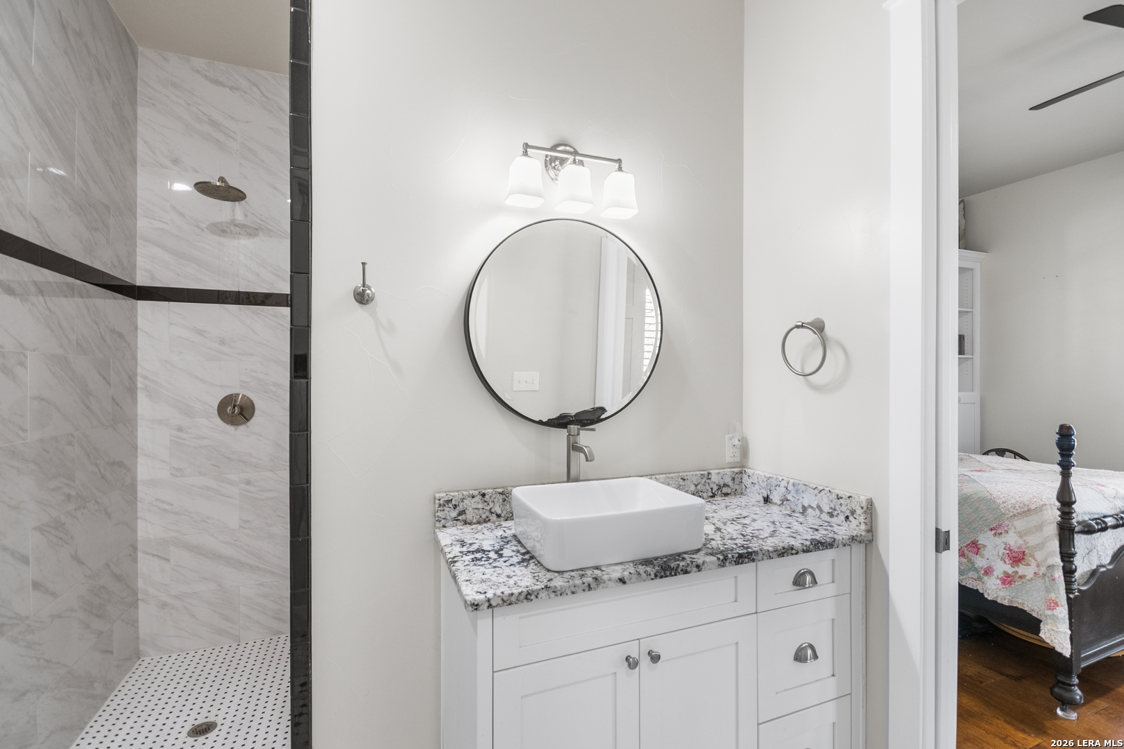 292 Fossil Ridge Boerne, TX 78006 - Photo 34 of 144 a bathroom with a granite countertop sink a mirror and shower