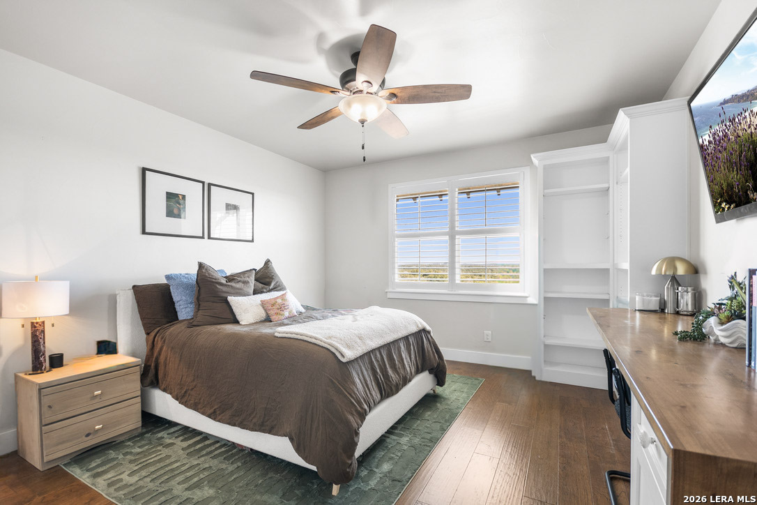 292 Fossil Ridge Boerne, TX 78006 - Photo 45 of 144 a bedroom with a large bed a flat tv screen and a dresser