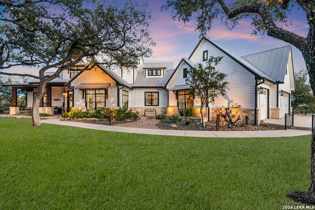 292 Fossil Ridge Boerne, TX 78006 - Photo 5 of 144 a front view of a house with a yard table and chairs