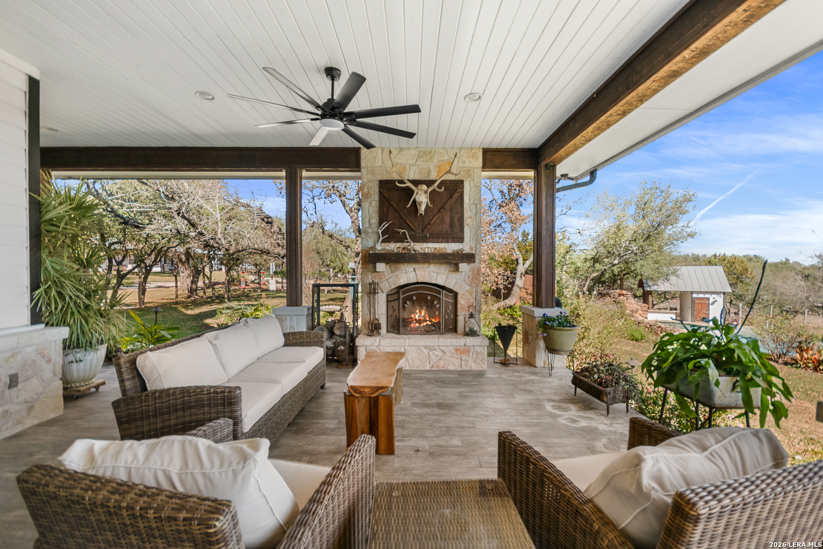 292 Fossil Ridge Boerne, TX 78006 - Photo 53 of 144 a living room with furniture a fireplace and a floor to ceiling window