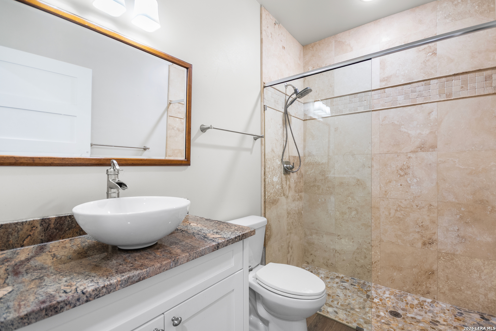 292 Fossil Ridge Boerne, TX 78006 - Photo 70 of 144 a bathroom with a granite countertop sink a toilet and a shower