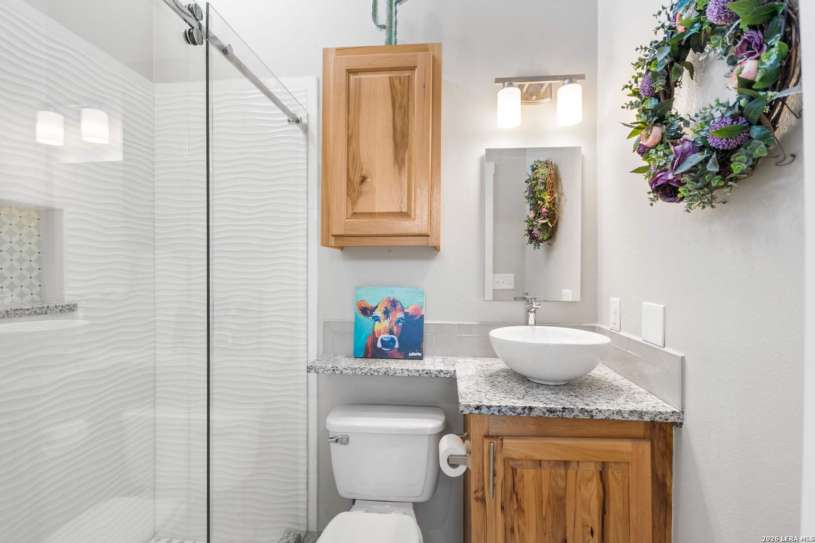 292 Fossil Ridge Boerne, TX 78006 - Photo 98 of 144 a bathroom with a granite countertop toilet sink and mirror