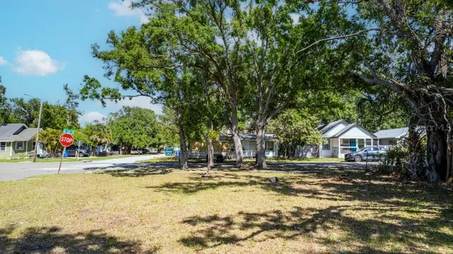 a view of a house with a yard and tree s