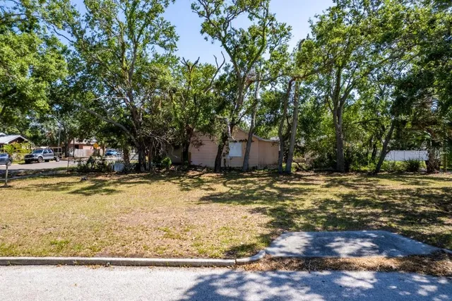 a view of a backyard with swimming pool