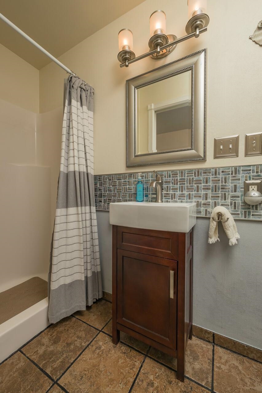 248 Majorca Road St. Augustine, FL 32080 - Photo 13 of 48 a bathroom with a sink a mirror and bathtub