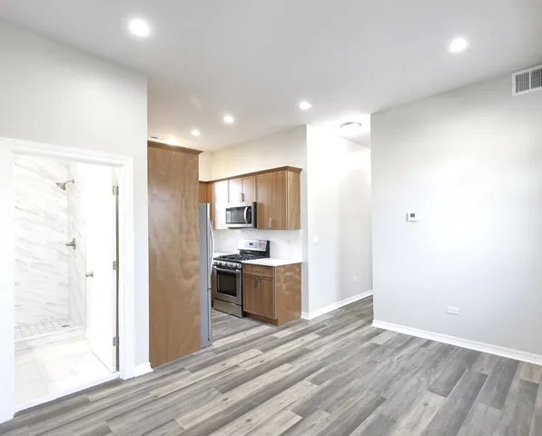 a view of a kitchen with a stove cabinets and wooden floor