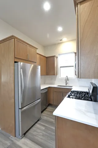 a kitchen with a refrigerator a sink and cabinets